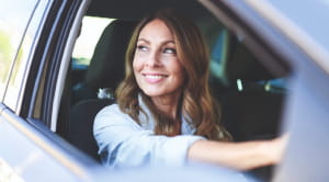 Motor insurance your questions answered woman smiling in car